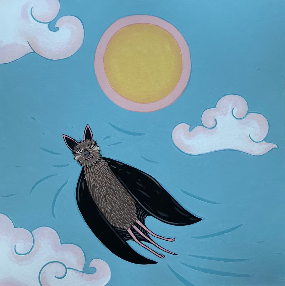 A bat soaring through a blue sky